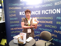 Tracey Signing Zinfandelity at the Romance Writers of American  2013 BEA booth Javits Center NYC